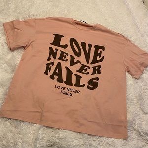 Love Never Fails Groovy Wave Font oversized shirt. Color coral/dusty rose. cute